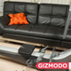An image of rowing machine in a room. It is the same width as the couch behind it.